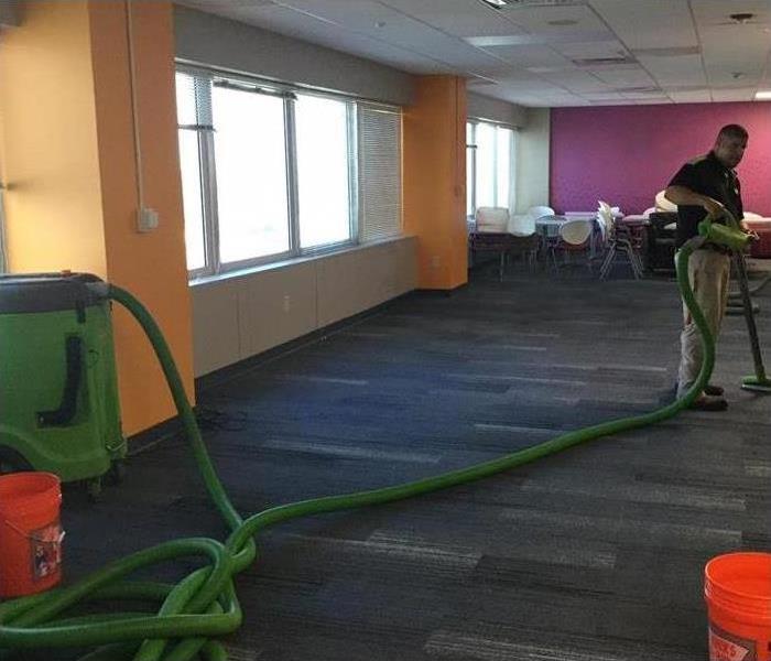 SERVPRO technician extracting water in a commercial building.
